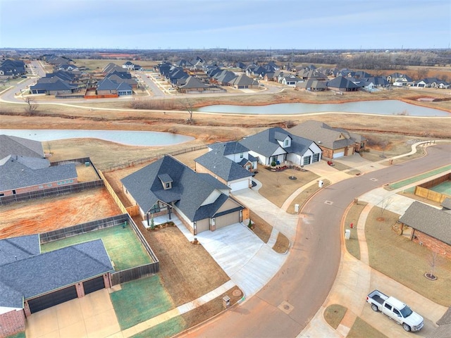 bird's eye view featuring a water view and a residential view