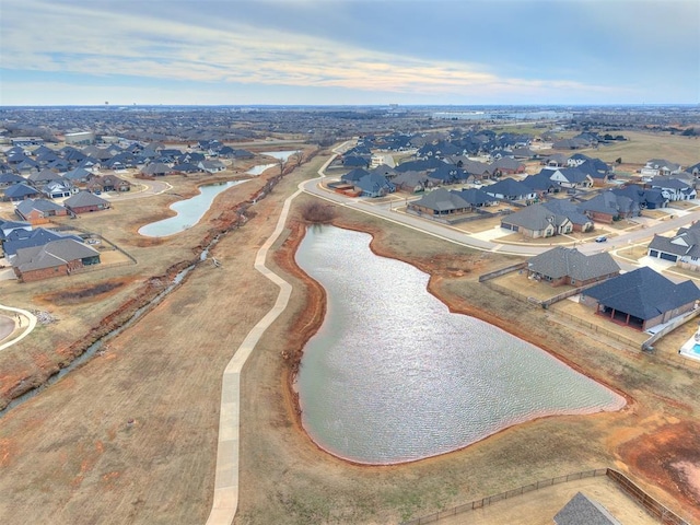 birds eye view of property with a water view and a residential view