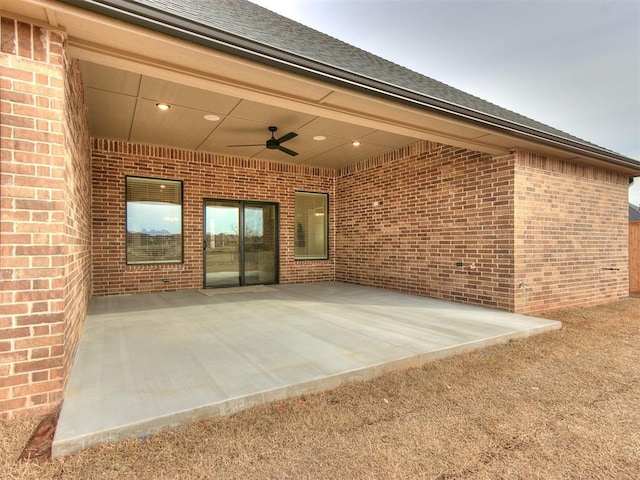 view of patio / terrace featuring ceiling fan and a garage