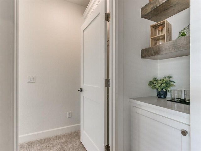 interior space with light carpet and baseboards