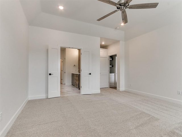 unfurnished bedroom with recessed lighting, baseboards, connected bathroom, and light colored carpet