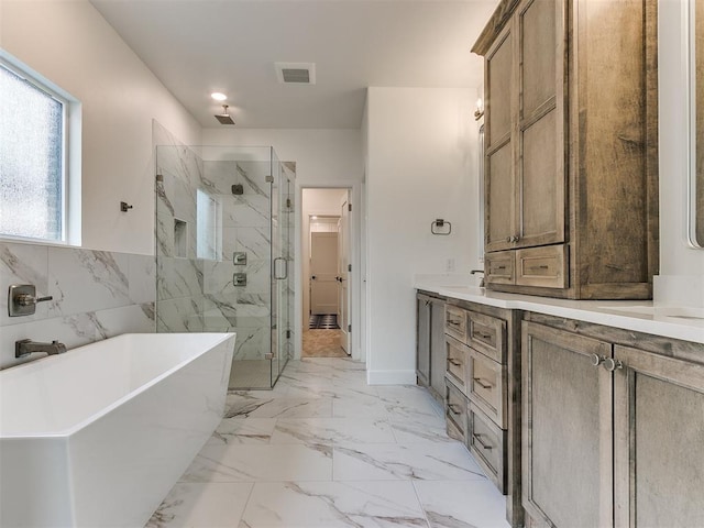 full bath featuring a freestanding tub, visible vents, vanity, marble finish floor, and a marble finish shower