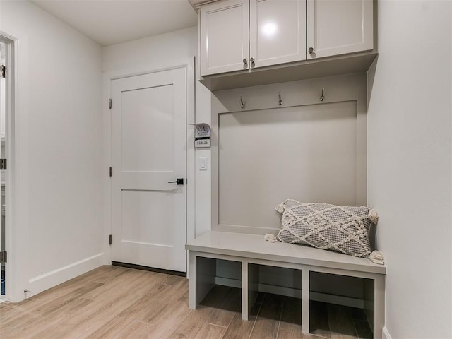 mudroom with light wood finished floors and baseboards