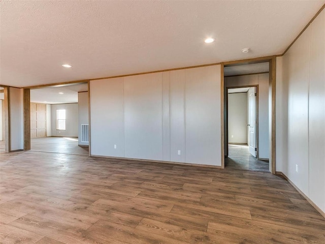28992 Oakwood Meadows Dr, Cashion, OK 73016 - spare room with wood-type flooring and a textured ceiling