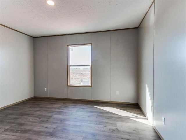 28992 Oakwood Meadows Dr, Cashion, OK 73016 - spare room featuring ornamental molding, a textured ceiling, and hardwood / wood-style flooring