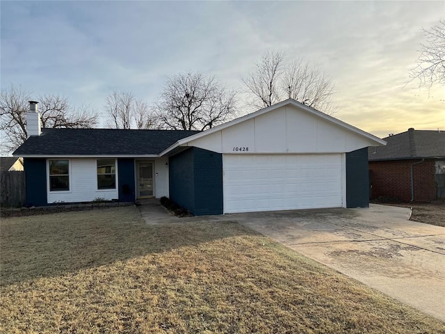 single story home featuring concrete driveway, a lawn, a chimney, and an attached garage