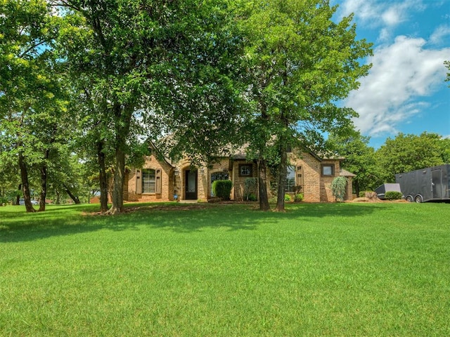 8275 Elk Grv, Blanchard, OK 73010 - view of property hidden behind natural elements featuring a front yard and brick siding