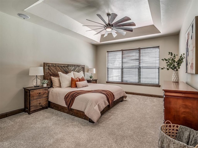 8275 Elk Grv, Blanchard, OK 73010 - bedroom featuring a tray ceiling, light colored carpet, and a ceiling fan