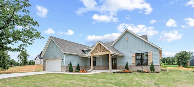 10949 Sandstone Ridge Way, Guthrie, OK 73044 - view of front of home featuring board and batten siding, concrete driveway, a front yard, brick siding, and a garage
