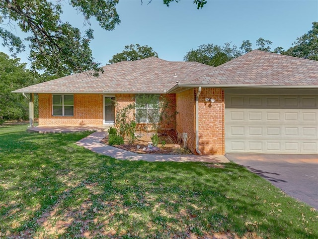 ranch-style house featuring a garage, brick siding, and a front yard