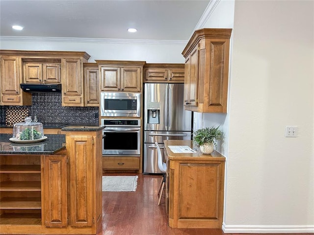 kitchen with crown molding, stainless steel appliances, tasteful backsplash, dark wood-type flooring, and under cabinet range hood