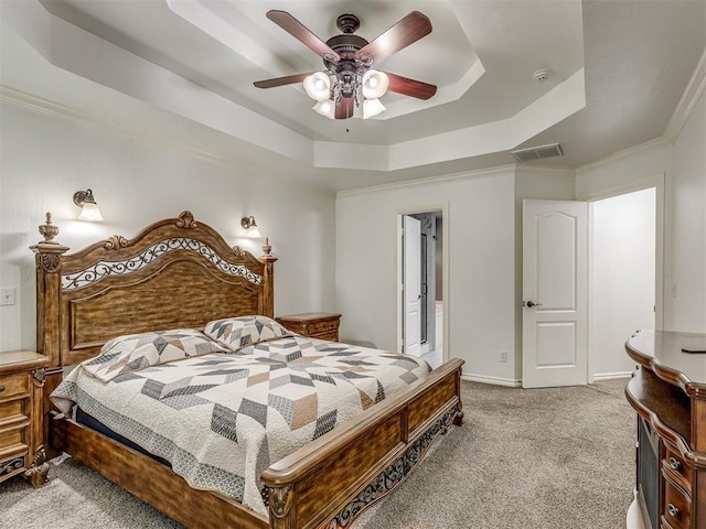 bedroom featuring light carpet, ceiling fan, baseboards, and a raised ceiling