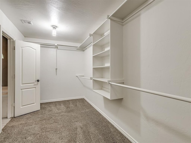 spacious closet with carpet and visible vents