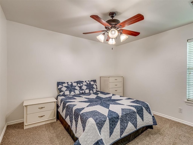 carpeted bedroom with a ceiling fan, visible vents, and baseboards