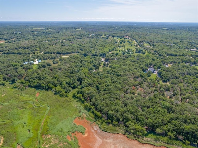 birds eye view of property featuring a forest view