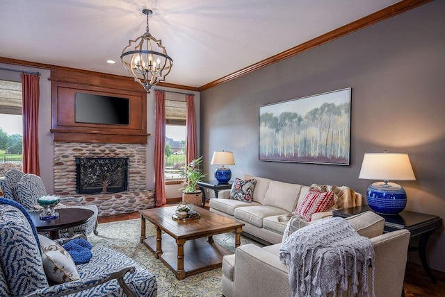 living room featuring a notable chandelier, wood finished floors, a fireplace, and crown molding