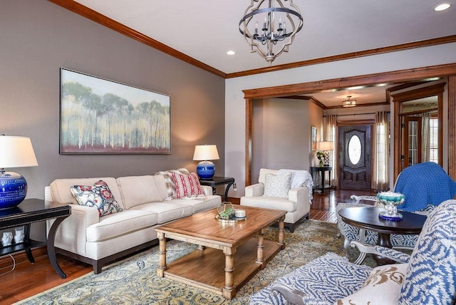 living area featuring an inviting chandelier, crown molding, recessed lighting, and wood finished floors