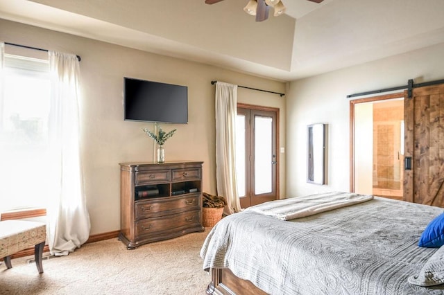 bedroom with light colored carpet, lofted ceiling, a barn door, and ceiling fan