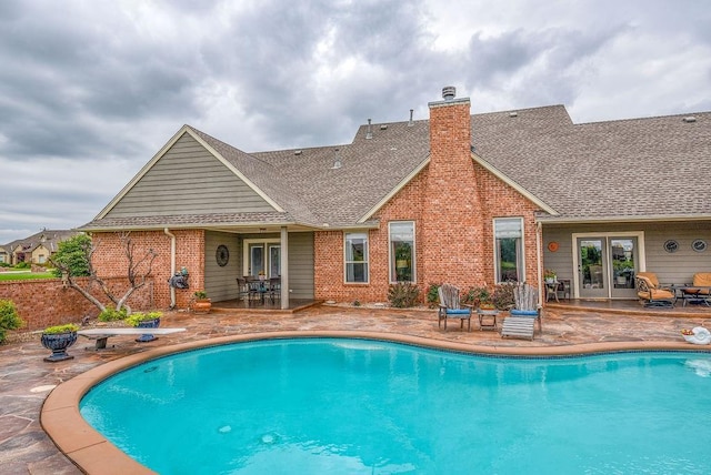 pool featuring french doors and a patio area