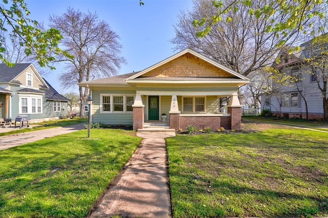 view of front of home with a porch and a front lawn