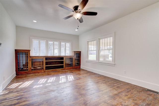unfurnished living room with visible vents, baseboards, ceiling fan, recessed lighting, and wood finished floors