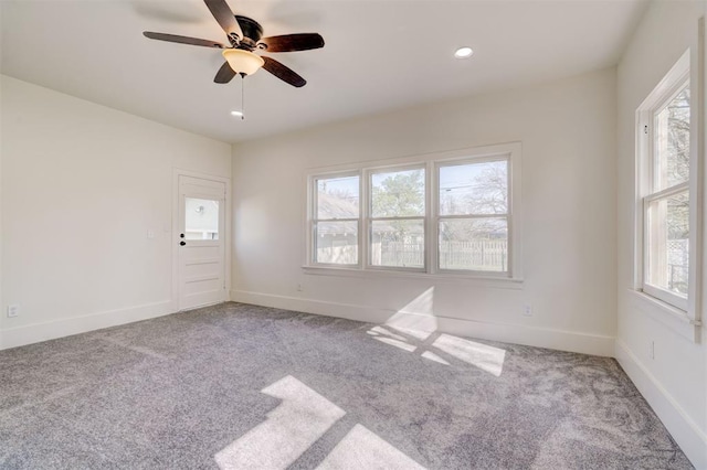 carpeted empty room with baseboards, a ceiling fan, and recessed lighting
