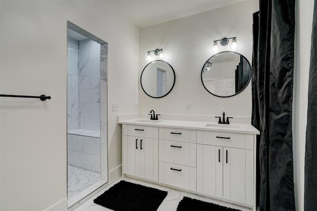 bathroom with a sink, double vanity, and tiled shower