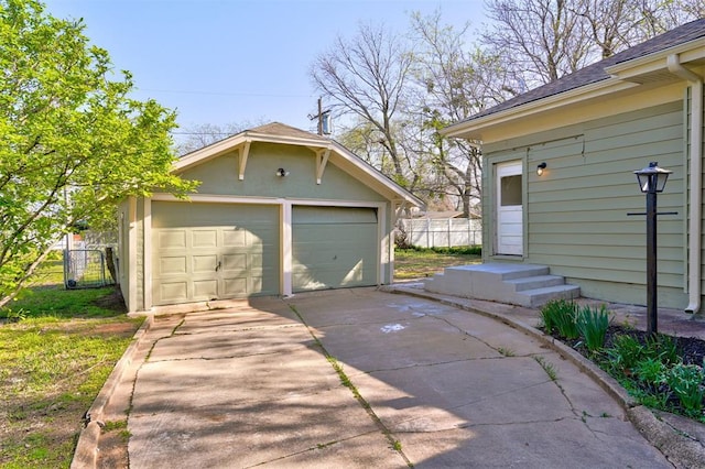 detached garage featuring fence