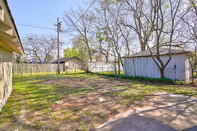 view of yard with an outdoor structure and fence
