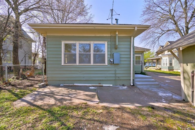 back of house with a patio and fence