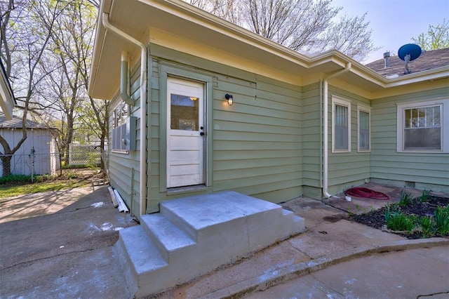 view of exterior entry with fence