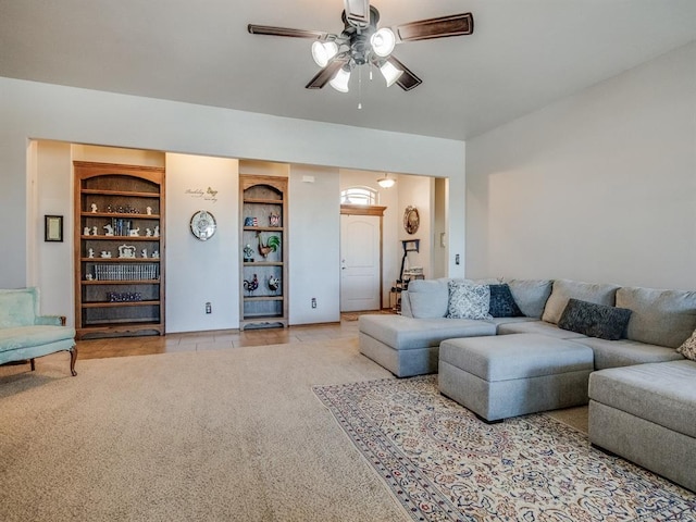 living room with light tile patterned floors, built in shelves, and a ceiling fan