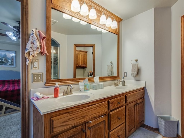 full bath with double vanity, visible vents, a ceiling fan, and a sink