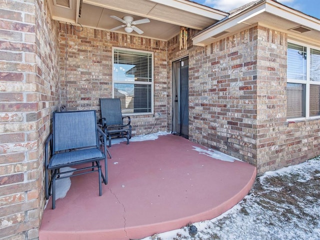 snow covered patio with ceiling fan