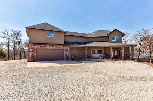 view of front of house with a shingled roof, concrete driveway, brick siding, and an attached garage