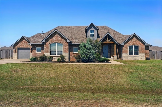7201 SW 122nd St, Oklahoma City, OK 73173 - craftsman-style home with driveway, stone siding, a front lawn, a garage, and fence