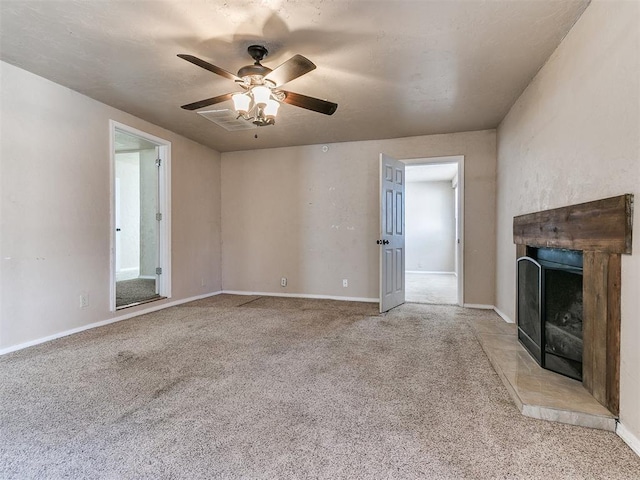 unfurnished living room with a ceiling fan, light colored carpet, a fireplace, and baseboards