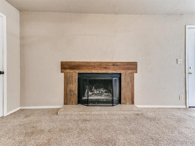 details with a fireplace with raised hearth, carpet, and baseboards