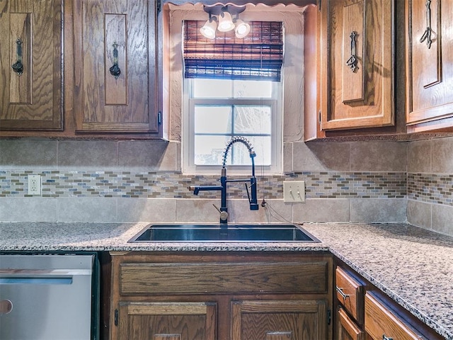 kitchen with dishwasher, tasteful backsplash, and a sink