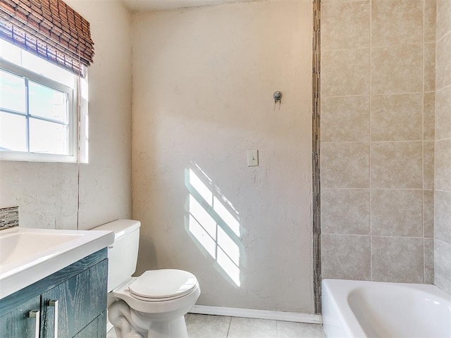 bathroom with toilet, vanity, baseboards, and tile patterned floors