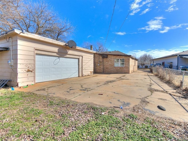 rear view of house with a garage and fence