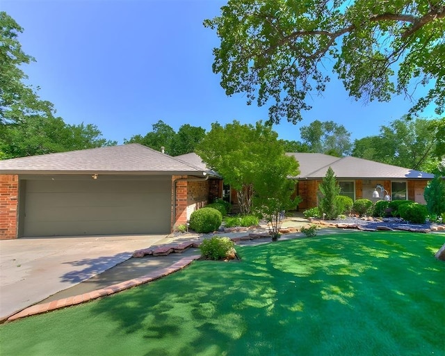 ranch-style house featuring brick siding, an attached garage, driveway, and a front lawn