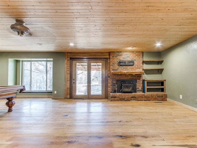 living room with wood ceiling, a wood stove, wood-type flooring, baseboards, and recessed lighting