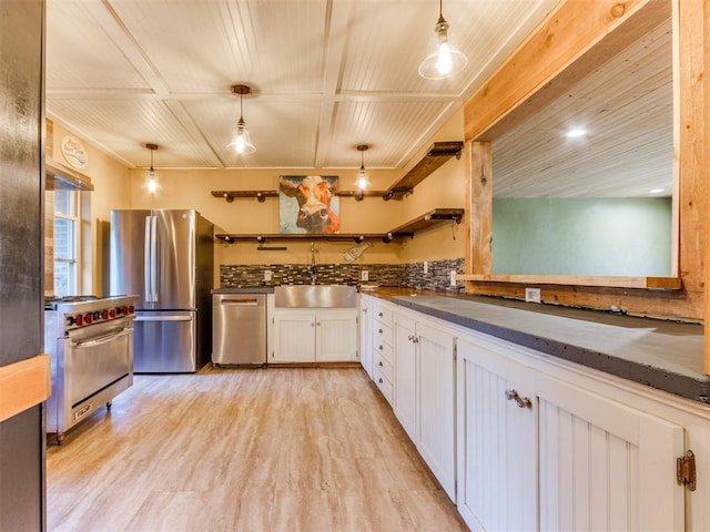 kitchen featuring stainless steel appliances, dark countertops, white cabinets, light wood finished floors, and open shelves
