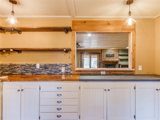 kitchen featuring white cabinets, hanging light fixtures, butcher block counters, wooden ceiling, and open shelves