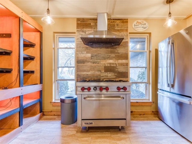kitchen featuring appliances with stainless steel finishes, exhaust hood, and hanging light fixtures