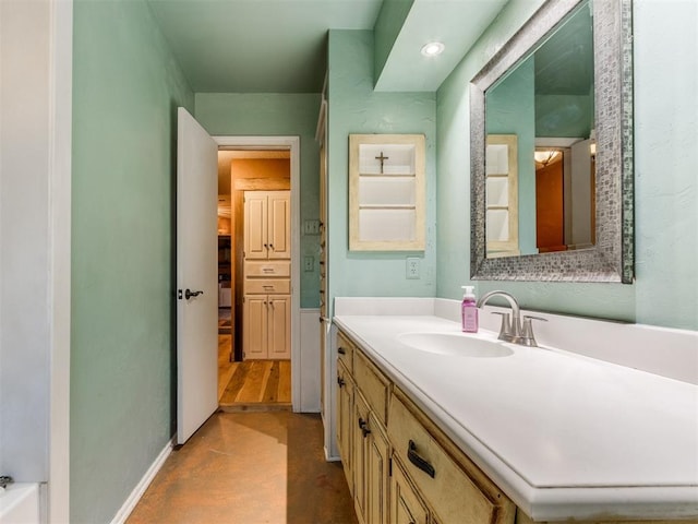 bathroom with vanity and concrete floors