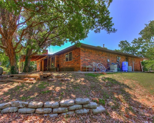 back of property featuring brick siding