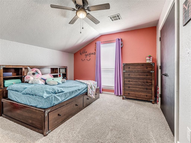 bedroom with carpet, visible vents, a textured wall, vaulted ceiling, and a textured ceiling