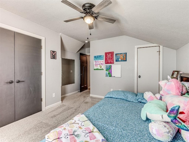 bedroom featuring vaulted ceiling, a textured ceiling, baseboards, and light colored carpet